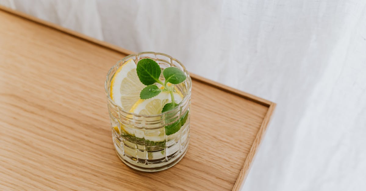 Making fruit syrup less viscous while retaining flavor - From above faceted thick wall glass of cold exotic drink on wooden desktop Making fruit syrup less viscous while retaining flavor - From above faceted thick wall glass of cold exotic drink on wooden desktop