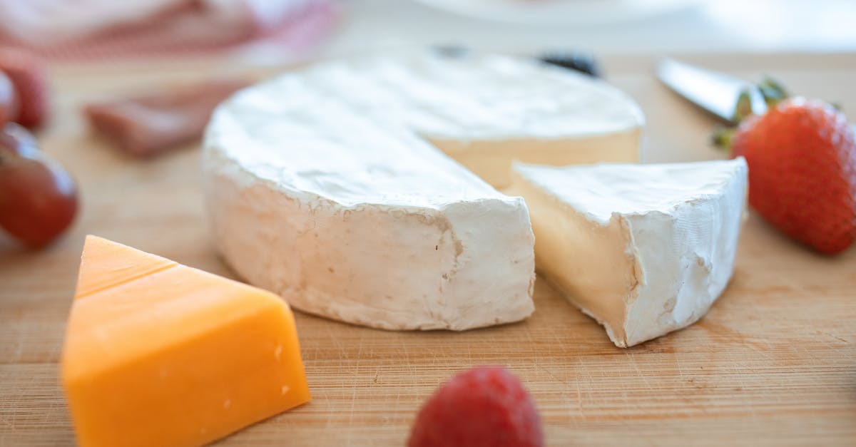 Making hard cheese from milk by vinegar - Sliced Cheese on Brown Wooden Table Making hard cheese from milk by vinegar - Sliced Cheese on Brown Wooden Table