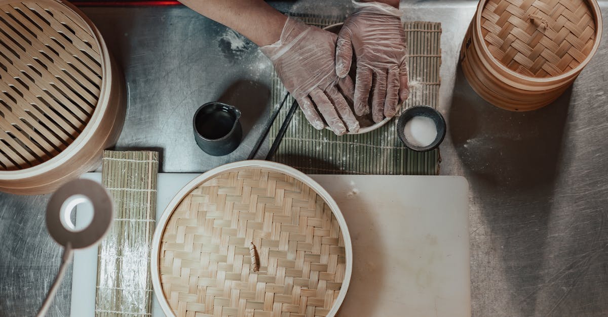 Making hazelnut flour with *just* blanched/peeled hazelnuts - Person in Gloves Cooking on the Table Beside Bamboo Baskets Making hazelnut flour with *just* blanched/peeled hazelnuts - Person in Gloves Cooking on the Table Beside Bamboo Baskets