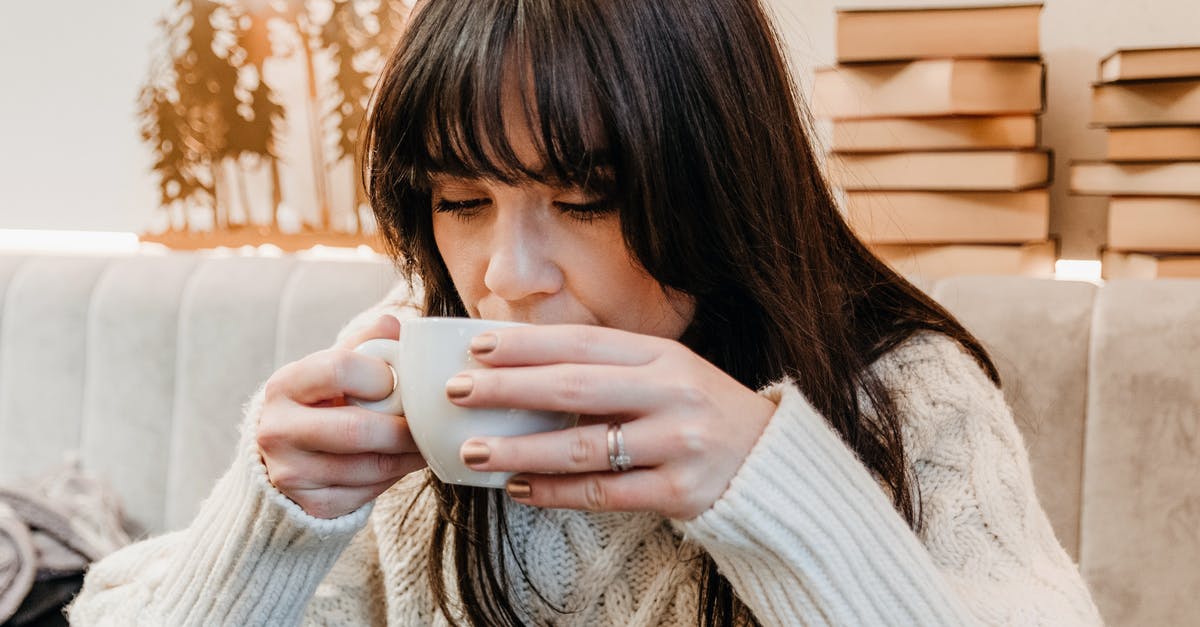 making iced tea with lowest caffeine content - Positive woman enjoying hot drink in cafeteria making iced tea with lowest caffeine content - Positive woman enjoying hot drink in cafeteria
