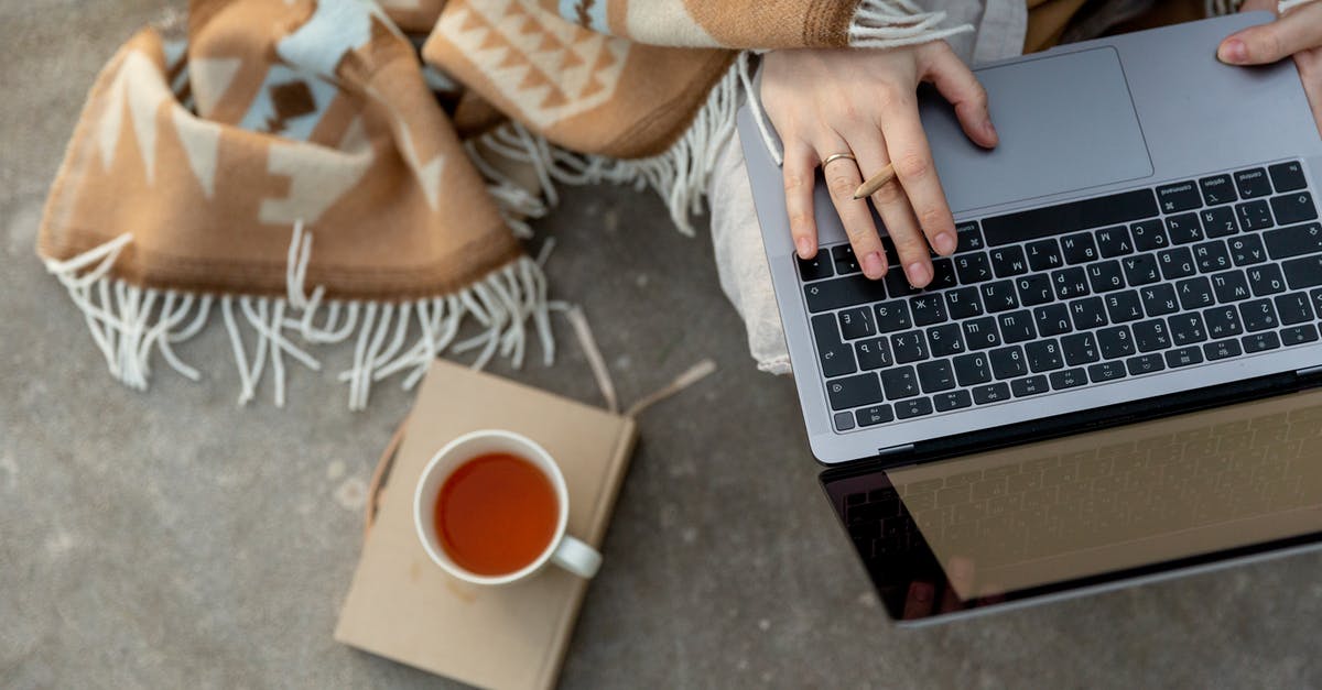 Making Mayo by hand , using whisk , emulsion breaks down - Crop unrecognizable freelancer typing on laptop during tea break Making Mayo by hand , using whisk , emulsion breaks down - Crop unrecognizable freelancer typing on laptop during tea break