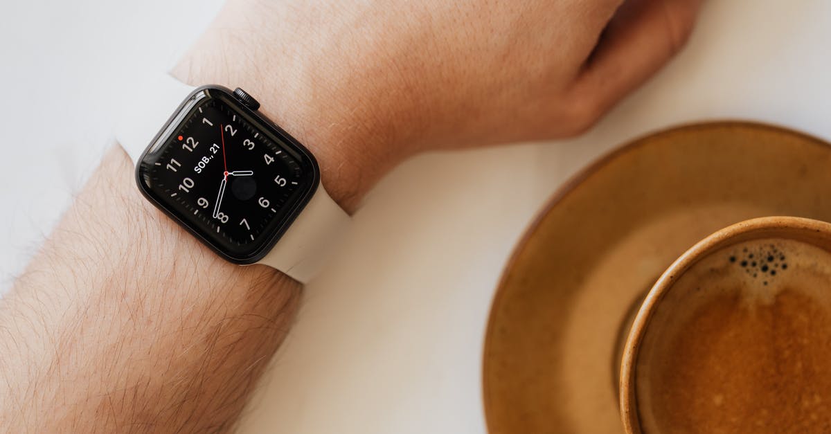 Making Mayo by hand , using whisk , emulsion breaks down - Smart watch on wrist of man drinking coffee Making Mayo by hand , using whisk , emulsion breaks down - Smart watch on wrist of man drinking coffee