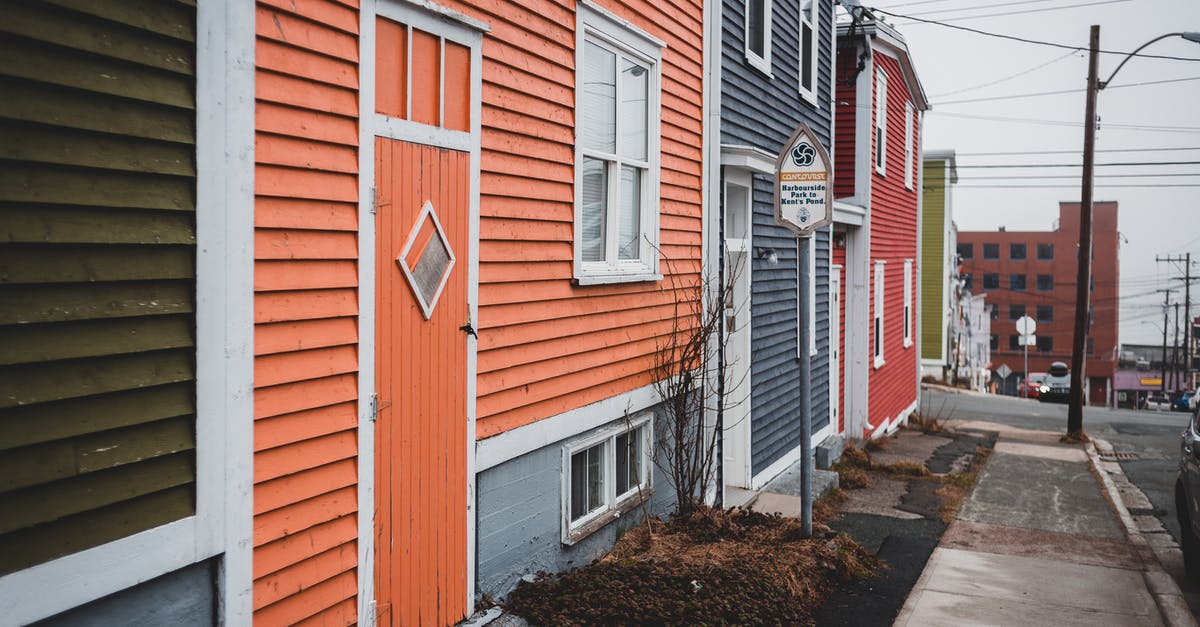 Making roast beef and Yorkshire pudding the old fashioned way - Bright old fashioned residential houses located near walkway on street in district of town with asphalt road and tall streetlamp