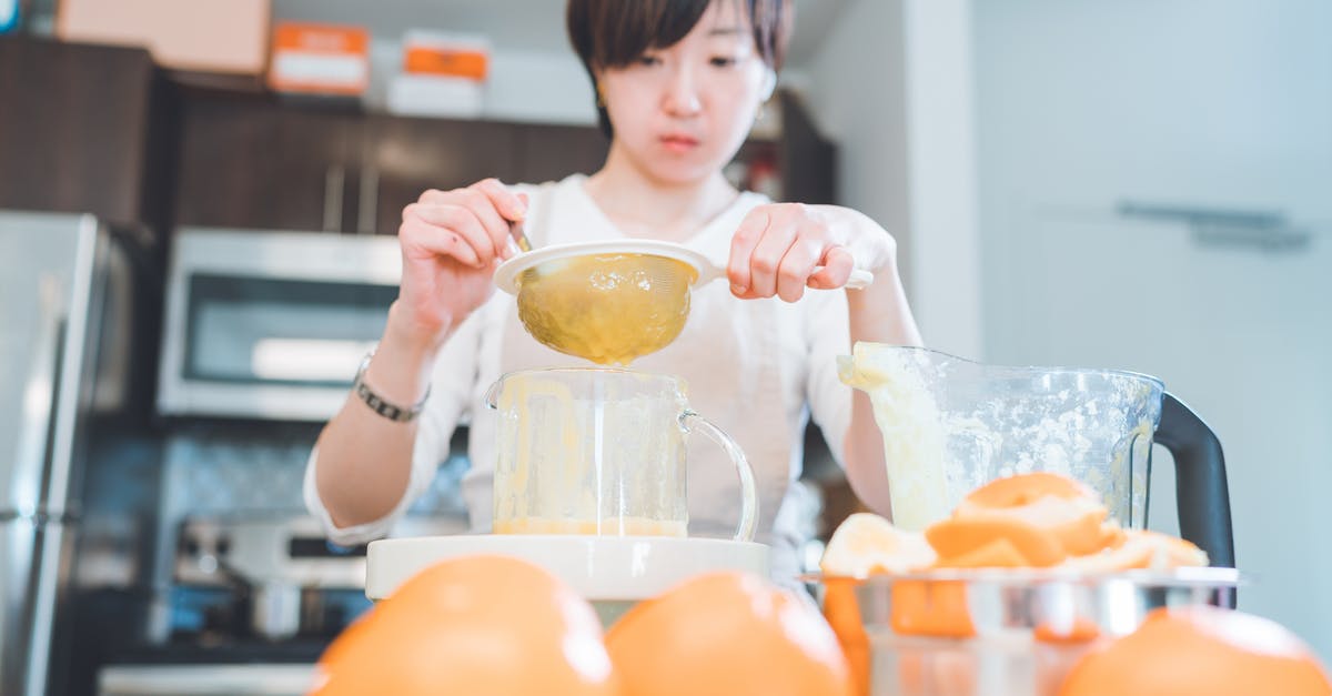 Making sorbet with fruit frozen before processing - A Woman Holding a Strainer Making sorbet with fruit frozen before processing - A Woman Holding a Strainer