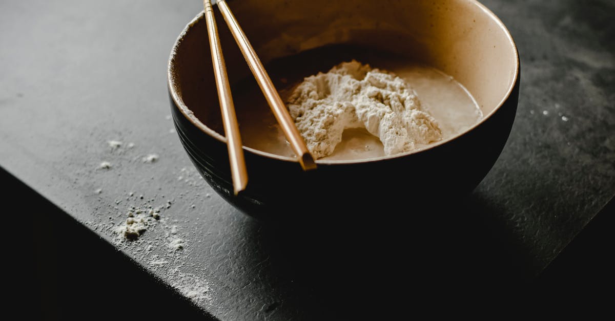 Making Sour Dough from Starter - Close-Up Photograph of Wooden Chopsticks on a Bowl with Dough Making Sour Dough from Starter - Close-Up Photograph of Wooden Chopsticks on a Bowl with Dough