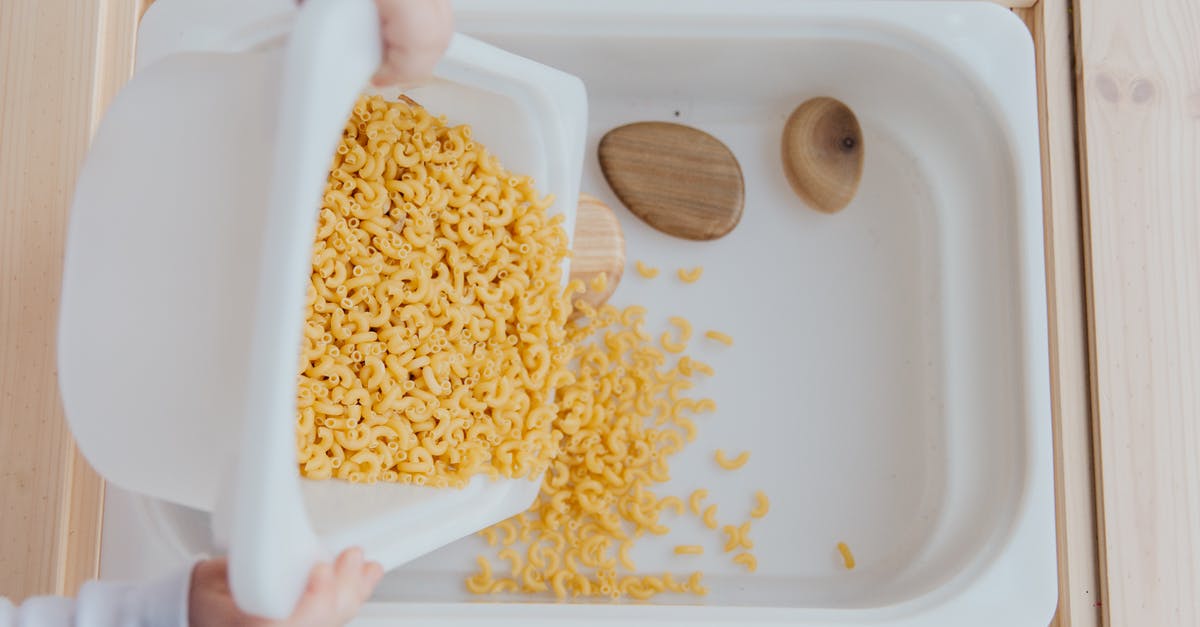 Making that little butter thing you put on top of steak - Unrecognizable crop kid adding raw pasta to white container Making that little butter thing you put on top of steak - Unrecognizable crop kid adding raw pasta to white container