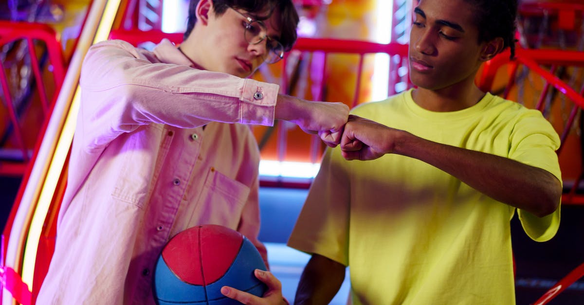 malted balls centers - Men Fist Bumping in an Amusement Center malted balls centers - Men Fist Bumping in an Amusement Center