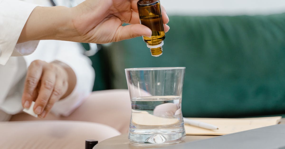 Marinades: Water vs Oil - Person Holding Clear Drinking Glass With Brown Liquid Marinades: Water vs Oil - Person Holding Clear Drinking Glass With Brown Liquid