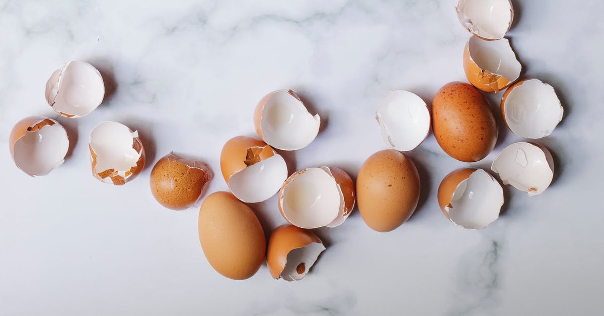 Meals to cook using a whole chicken - Top view of pile of brown shells and whole eggs scattered on marble table in kitchen on sunny day Meals to cook using a whole chicken - Top view of pile of brown shells and whole eggs scattered on marble table in kitchen on sunny day