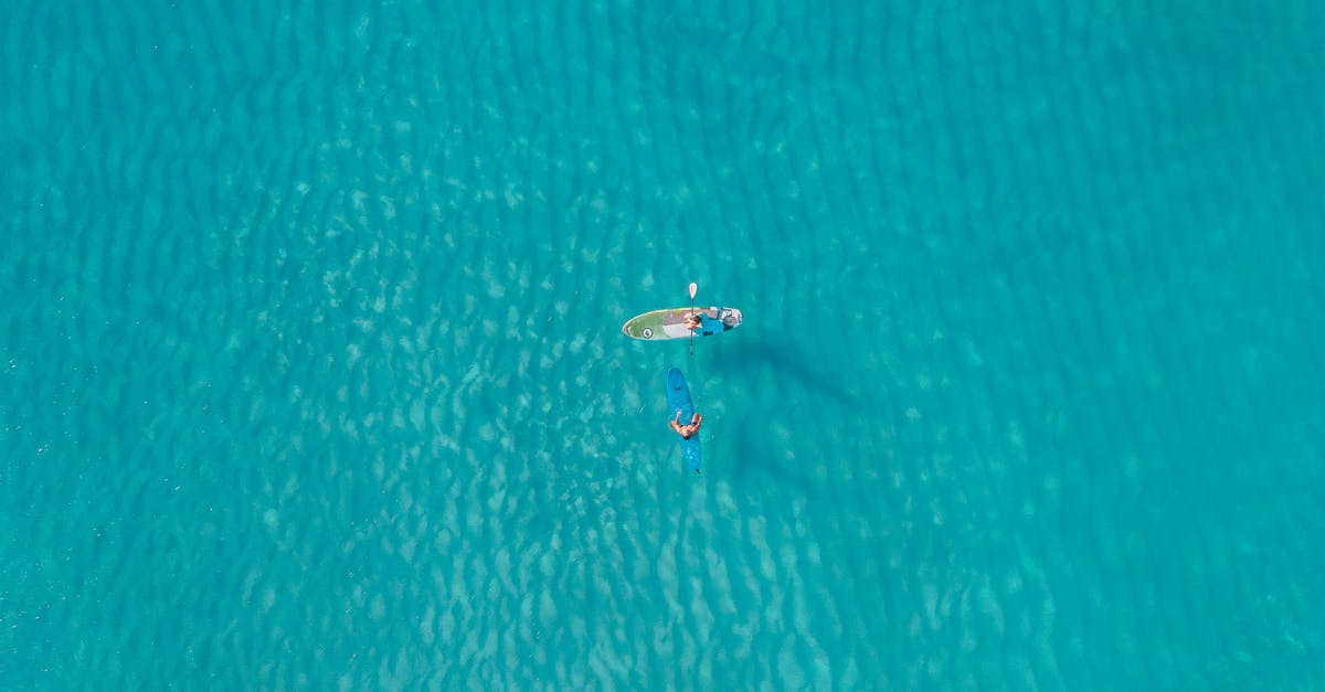 Measurement of water - Person in White Shirt Riding on White Boat on Blue Water Measurement of water - Person in White Shirt Riding on White Boat on Blue Water