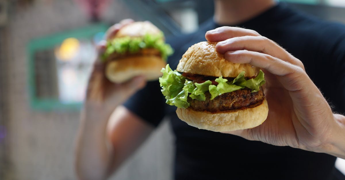 Meat defrosting too fast - Person Holding Two Hamburgers Meat defrosting too fast - Person Holding Two Hamburgers