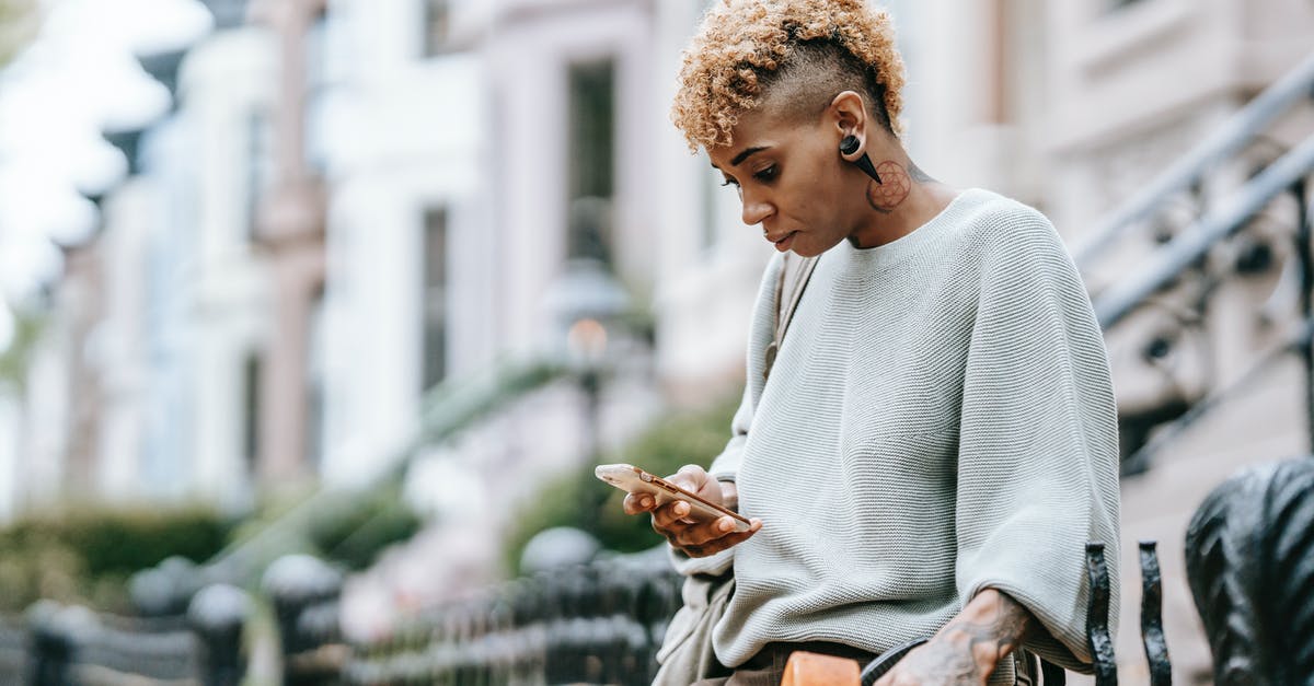 Meat loses weight after some time - Attentive ethnic woman chatting on smartphone in town Meat loses weight after some time - Attentive ethnic woman chatting on smartphone in town