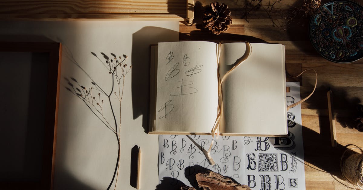 Meringue Imitation to practice decoration - Top view of opened notebook with pencil and dried flower placed on wooden table near other decorative elements illustrating handwriting practice as hobby Meringue Imitation to practice decoration - Top view of opened notebook with pencil and dried flower placed on wooden table near other decorative elements illustrating handwriting practice as hobby