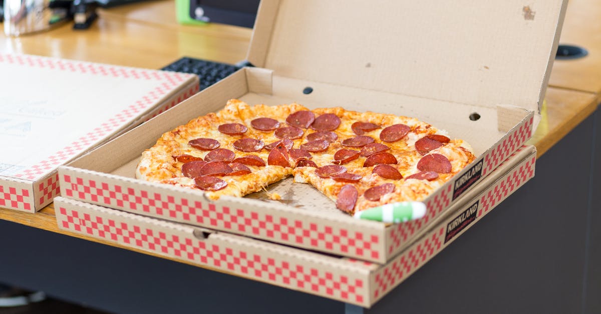Mexican cheeses on otherwise Italian pizza - Pizza With Box on Table Mexican cheeses on otherwise Italian pizza - Pizza With Box on Table