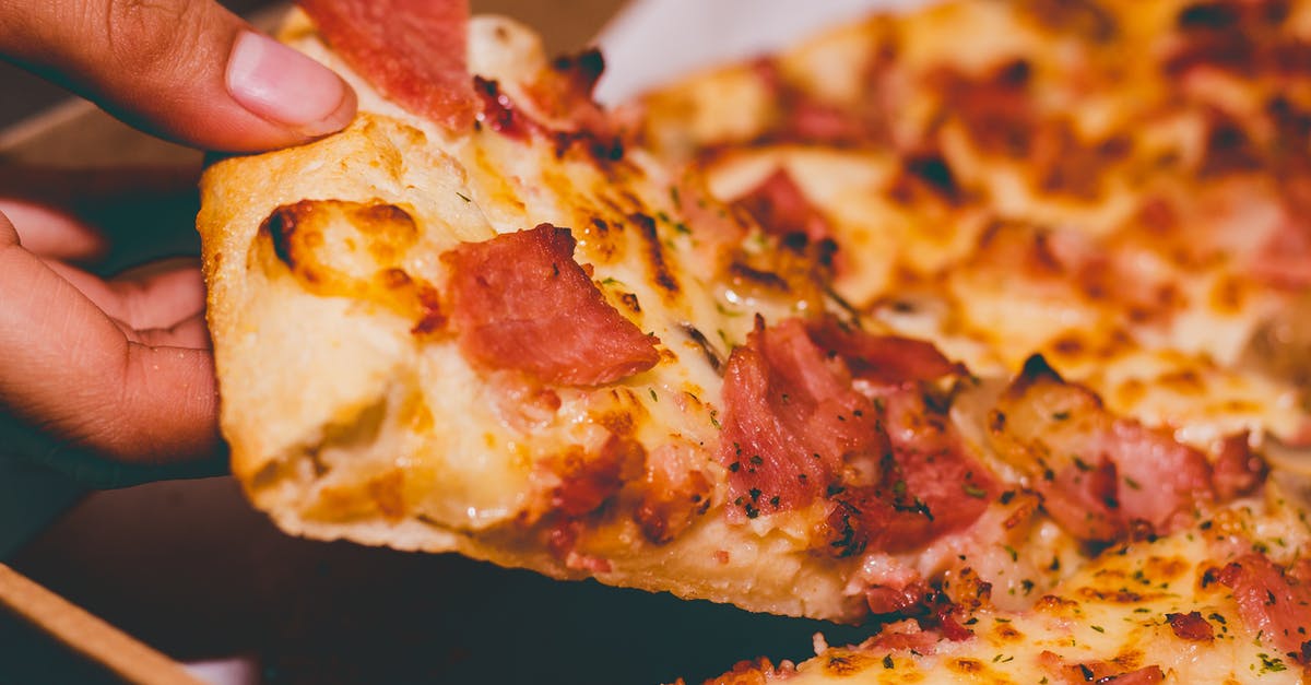 Microwave Crust - Close-Up Photo of Person Holding Pizza Microwave Crust - Close-Up Photo of Person Holding Pizza