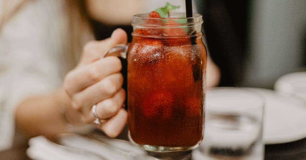 Mint vs Peppermint - Crop female drinking cold beverage in bar Mint vs Peppermint - Crop female drinking cold beverage in bar