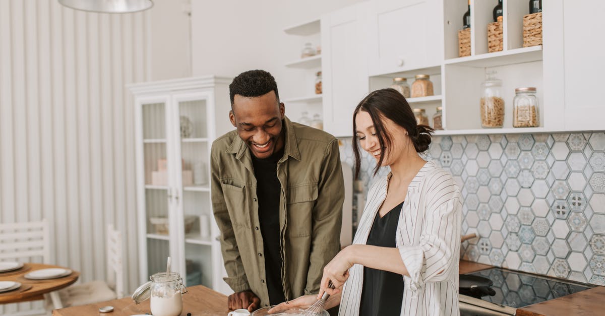Mixing cheesecake batter with an immersion blender - A Couple Making a Pancake Batter Mixing cheesecake batter with an immersion blender - A Couple Making a Pancake Batter