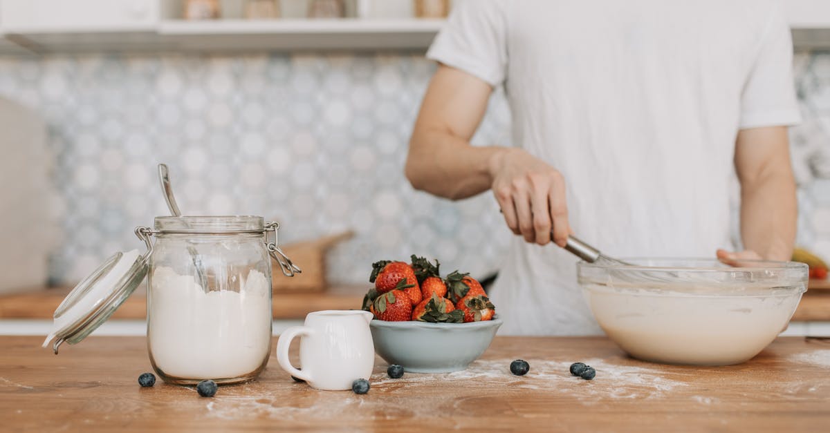 Mixing cheesecake batter with an immersion blender - A Man Whisking a Pancake Batter Mixing cheesecake batter with an immersion blender - A Man Whisking a Pancake Batter