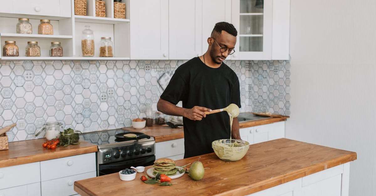 Mixing cheesecake batter with an immersion blender - A Man Mixing Batter in a Bowl Mixing cheesecake batter with an immersion blender - A Man Mixing Batter in a Bowl
