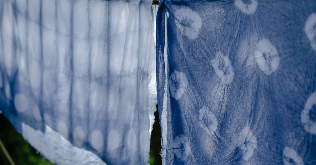 Molasses - dry vs. wet - Clean fabric drying on clothesline on sunny day Molasses - dry vs. wet - Clean fabric drying on clothesline on sunny day