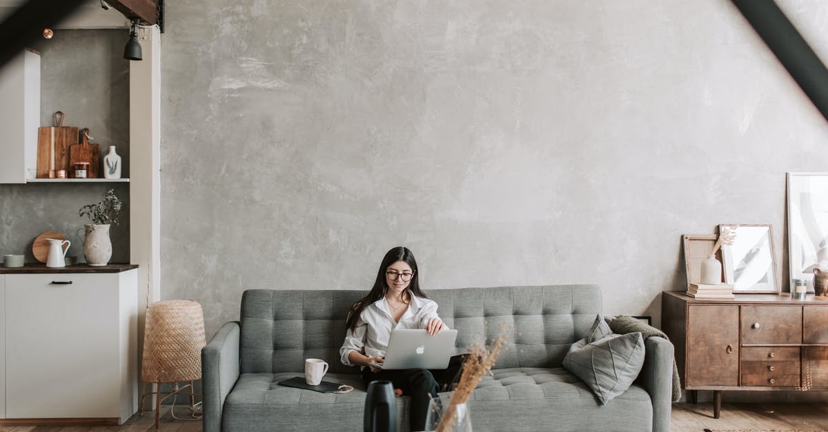 Most optimal pizza type or style for home oven? - Happy female remote worker in eyeglasses sitting on cozy sofa with netbook and cup of coffee in loft style room with wooden floor and concrete wall Most optimal pizza type or style for home oven? - Happy female remote worker in eyeglasses sitting on cozy sofa with netbook and cup of coffee in loft style room with wooden floor and concrete wall
