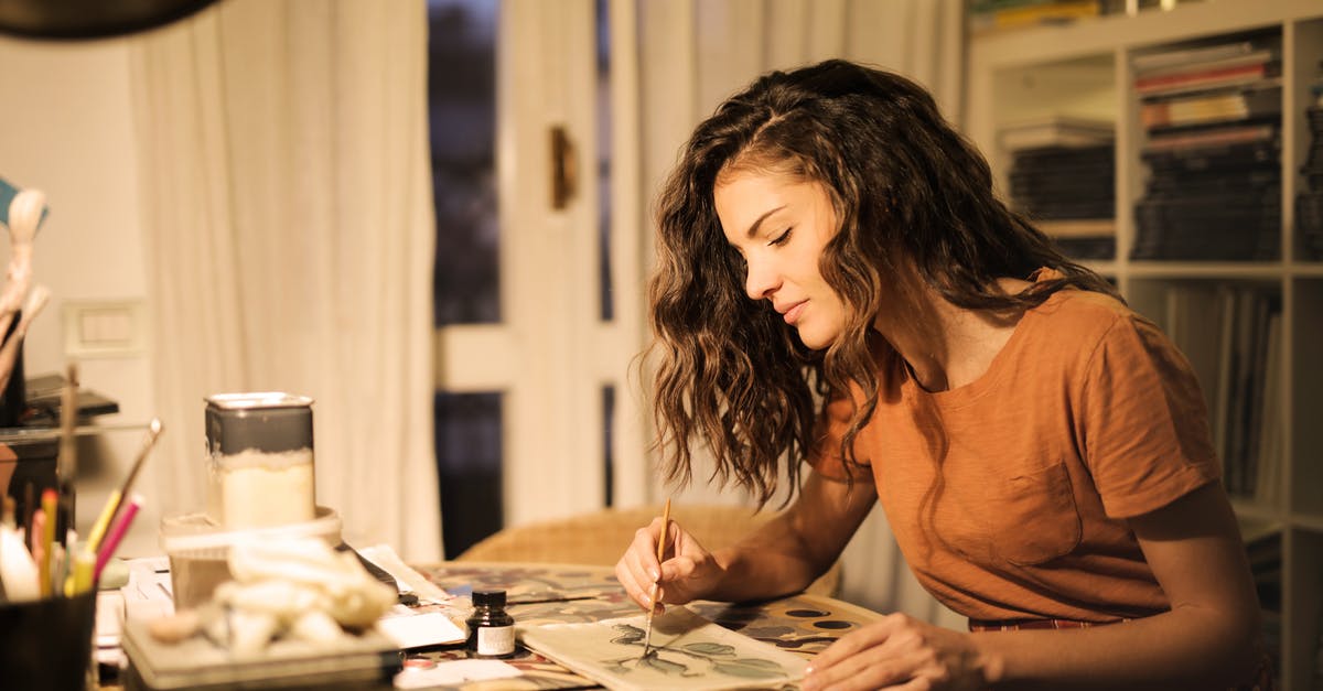 Multiple tea infusions and caffeine concentration - Young woman painting on paper at workplace Multiple tea infusions and caffeine concentration - Young woman painting on paper at workplace