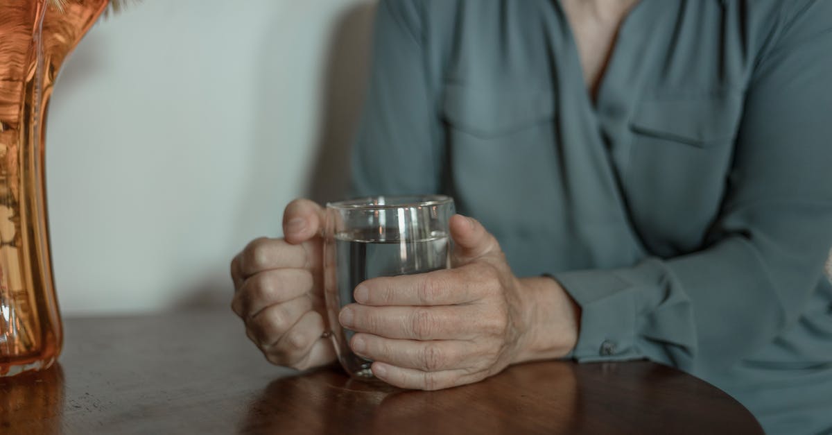 My drink electrocuted me - Person in Blue Dress Shirt Holding Clear Drinking Glass My drink electrocuted me - Person in Blue Dress Shirt Holding Clear Drinking Glass