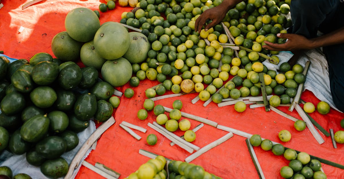 My mango and lime achar is fermenting in the mustard oil - Crop ethnic person with harvest of exotic fruits My mango and lime achar is fermenting in the mustard oil - Crop ethnic person with harvest of exotic fruits
