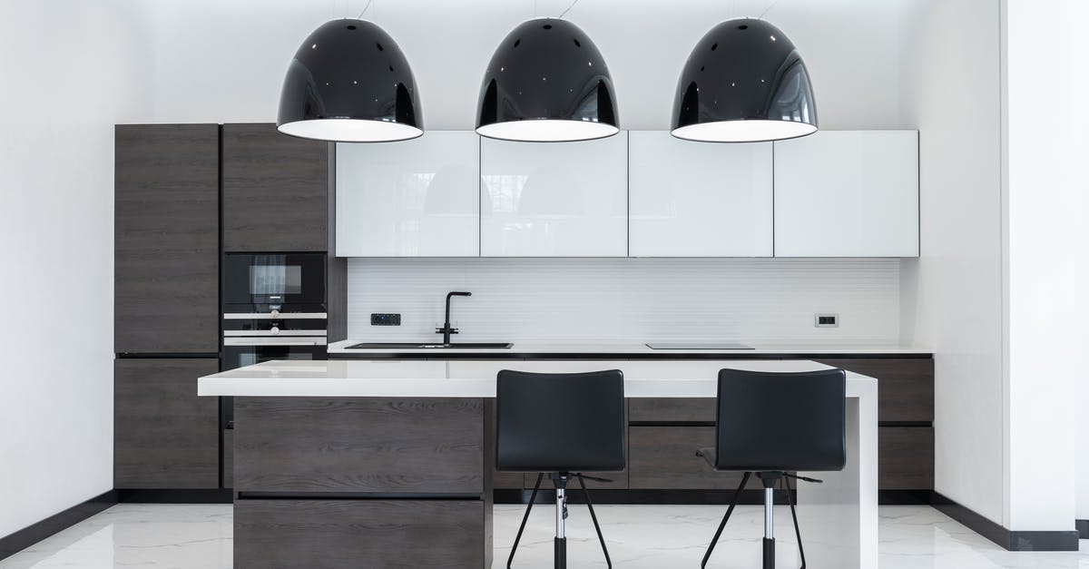 My new convection/convention oven will not bake anything correctly - Creative lamps hanging over table with chairs in spacious kitchen with modern furniture and appliances