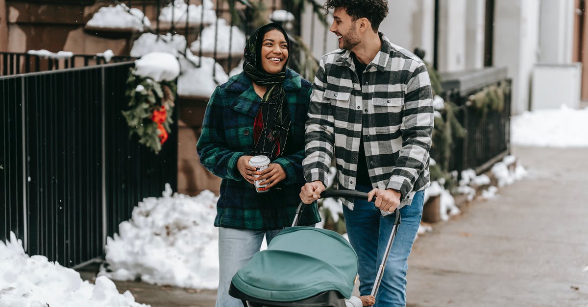 My sourdough starter is going wrong in every possible way - Happy ethnic couple walking with stroller on street in residential city district My sourdough starter is going wrong in every possible way - Happy ethnic couple walking with stroller on street in residential city district