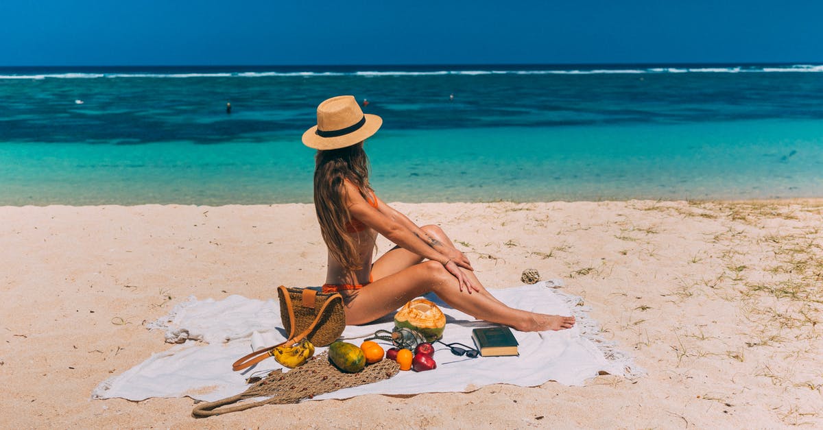 Mysterious bitter taste from tropical fruits and coconut - A Woman Sitting on a Beach Towel Mysterious bitter taste from tropical fruits and coconut - A Woman Sitting on a Beach Towel