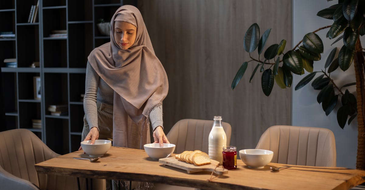 mysterious green middle eastern plums - Ethnic housewife serving food on table for dinner mysterious green middle eastern plums - Ethnic housewife serving food on table for dinner