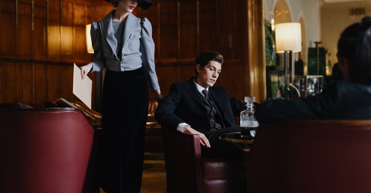 Mysterious Minty Yams? - Man in Black Suit Standing Beside Woman in White Dress Shirt Mysterious Minty Yams? - Man in Black Suit Standing Beside Woman in White Dress Shirt