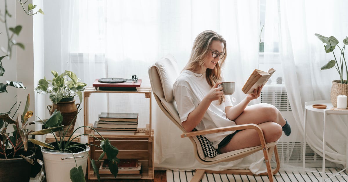 Need help cleaning an old aluminum coffee pot - Cheerful young female in eyeglasses with cup of beverage reading textbook in armchair between potted plants in house room Need help cleaning an old aluminum coffee pot - Cheerful young female in eyeglasses with cup of beverage reading textbook in armchair between potted plants in house room