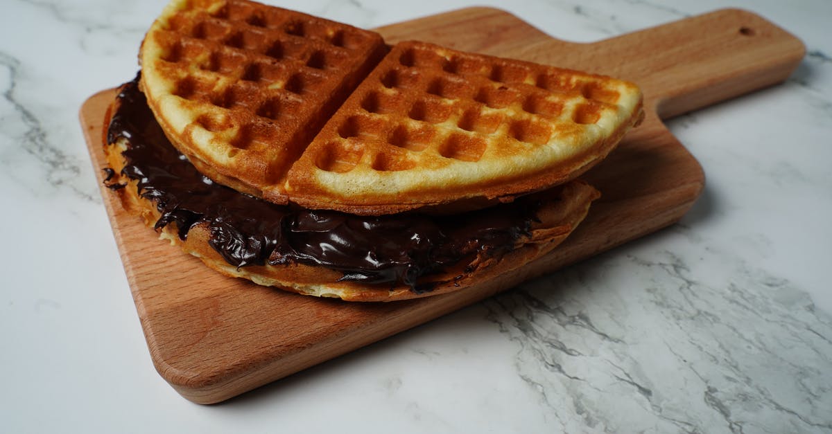 Nestle Cream "Ashta" - Waffle on Brown Wooden Chopping Board Nestle Cream "Ashta" - Waffle on Brown Wooden Chopping Board