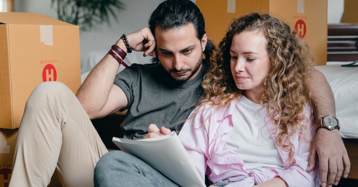 New takes on recipe format - Pensive male and female in casual clothes sitting together among boxes and writing notes in notebook while leaning on bed New takes on recipe format - Pensive male and female in casual clothes sitting together among boxes and writing notes in notebook while leaning on bed