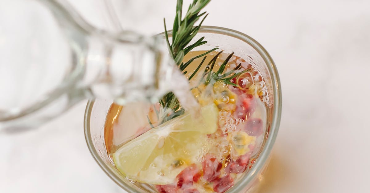 New takes on recipe format - From above of glass bottle pouring water into glass with sprig of rosemary and slice of lemon placed on marble surface New takes on recipe format - From above of glass bottle pouring water into glass with sprig of rosemary and slice of lemon placed on marble surface