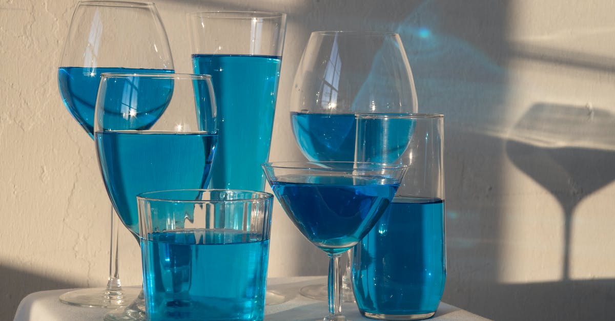Nonalcoholic Substitute for Marsala Wine - Transparent glasses filled with blue alcoholic drink standing on white tablecloth in sunlight Nonalcoholic Substitute for Marsala Wine - Transparent glasses filled with blue alcoholic drink standing on white tablecloth in sunlight