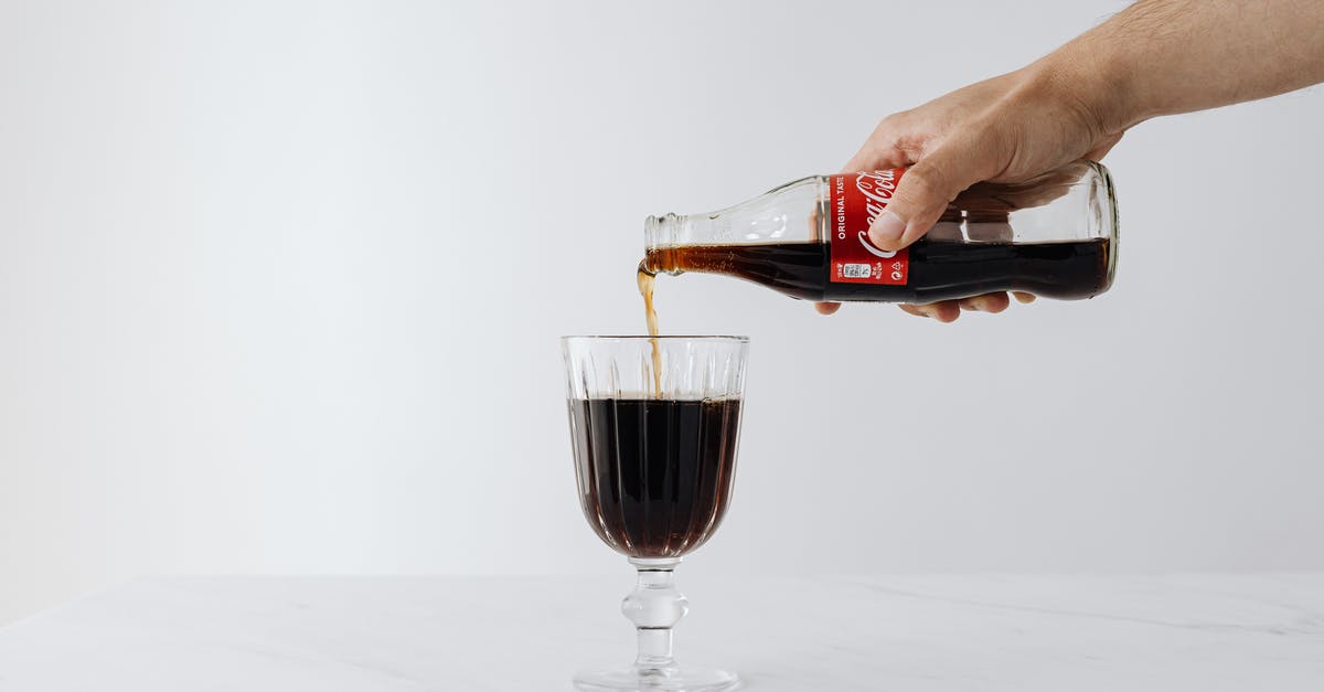 Nonalcoholic Substitute for Marsala Wine - Crop man pouring soda into wineglass on table Nonalcoholic Substitute for Marsala Wine - Crop man pouring soda into wineglass on table
