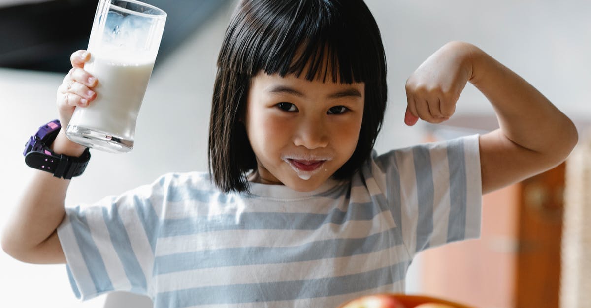 Nutrient composition of milk vs. home-made kefir - Asian girl with milk on lips Nutrient composition of milk vs. home-made kefir - Asian girl with milk on lips