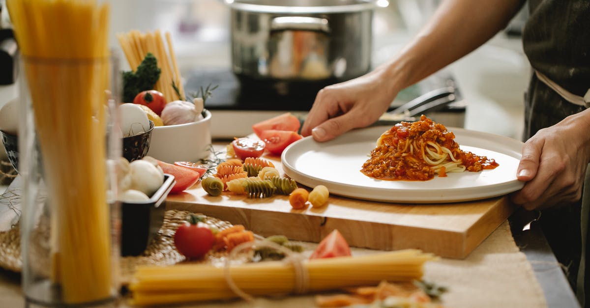 Nutrient content of ground bison meat - Crop anonymous cook standing at table with various ingredients and cooking pasta with meat and tomatoes Nutrient content of ground bison meat - Crop anonymous cook standing at table with various ingredients and cooking pasta with meat and tomatoes