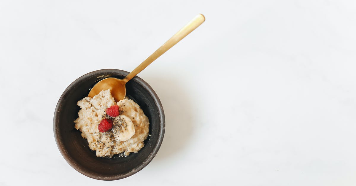 Oat starch to sugar conversion in oat milk - Brown Wooden Spoon on Black Ceramic Bowl Oat starch to sugar conversion in oat milk - Brown Wooden Spoon on Black Ceramic Bowl
