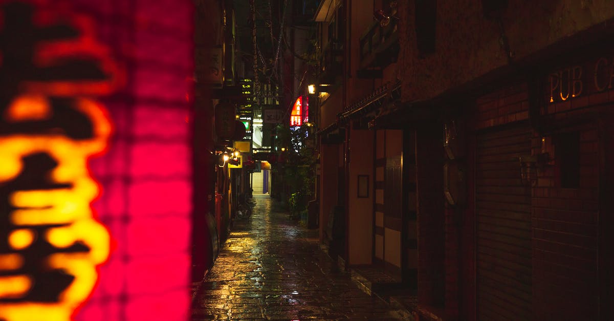 old electric Farberware wok - Narrow street with wet cobblestone footpath old electric Farberware wok - Narrow street with wet cobblestone footpath