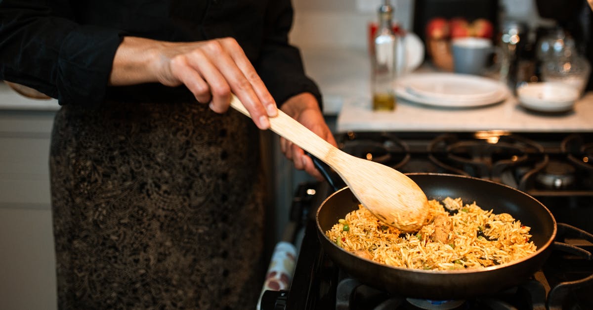 Open Fire Paella - do I need to fry rice? - A Person Cooking a Rice Dish Open Fire Paella - do I need to fry rice? - A Person Cooking a Rice Dish