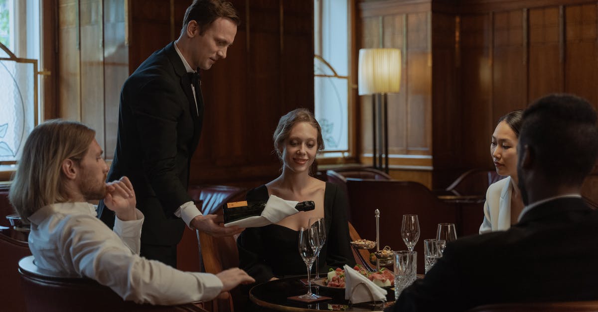 Opening wine bottle with rounded top using a waiter's friend - Photo of a Waiter Pouring Wine into Glasses Opening wine bottle with rounded top using a waiter's friend - Photo of a Waiter Pouring Wine into Glasses