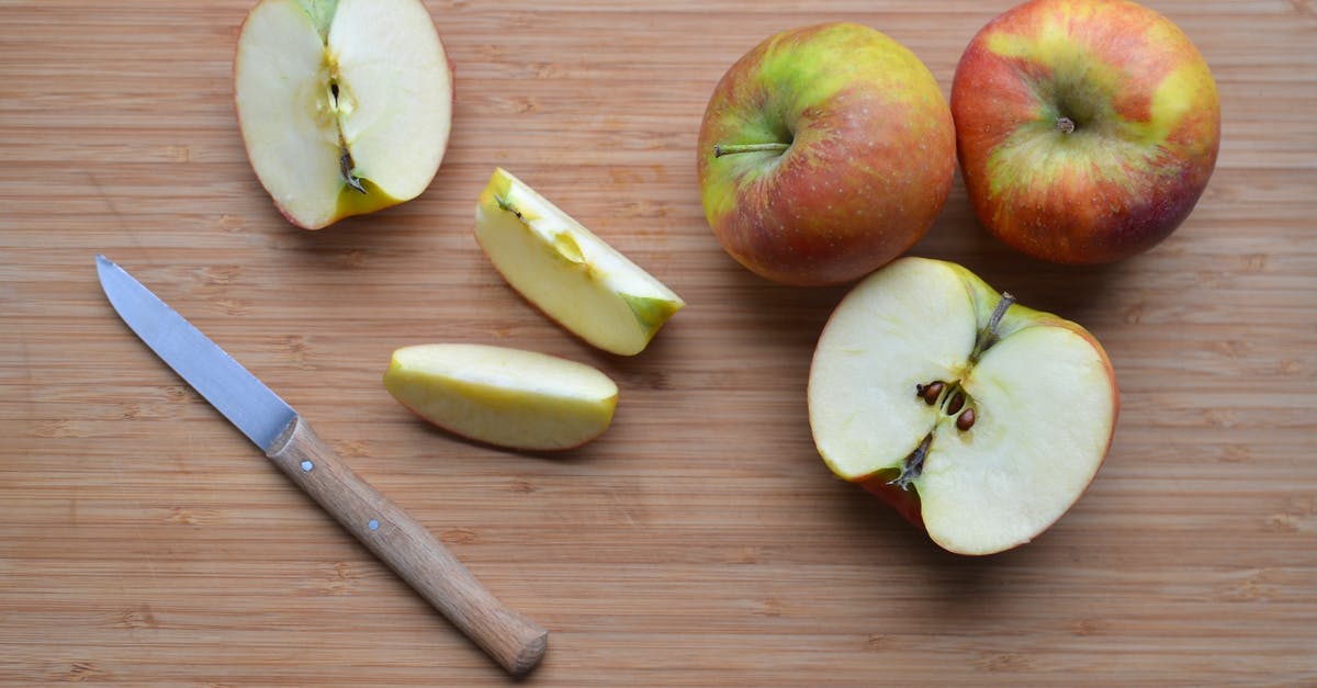 Optimal shape to cut apples for apple pie - Slices of ripe apples and knife on wooden surface Optimal shape to cut apples for apple pie - Slices of ripe apples and knife on wooden surface