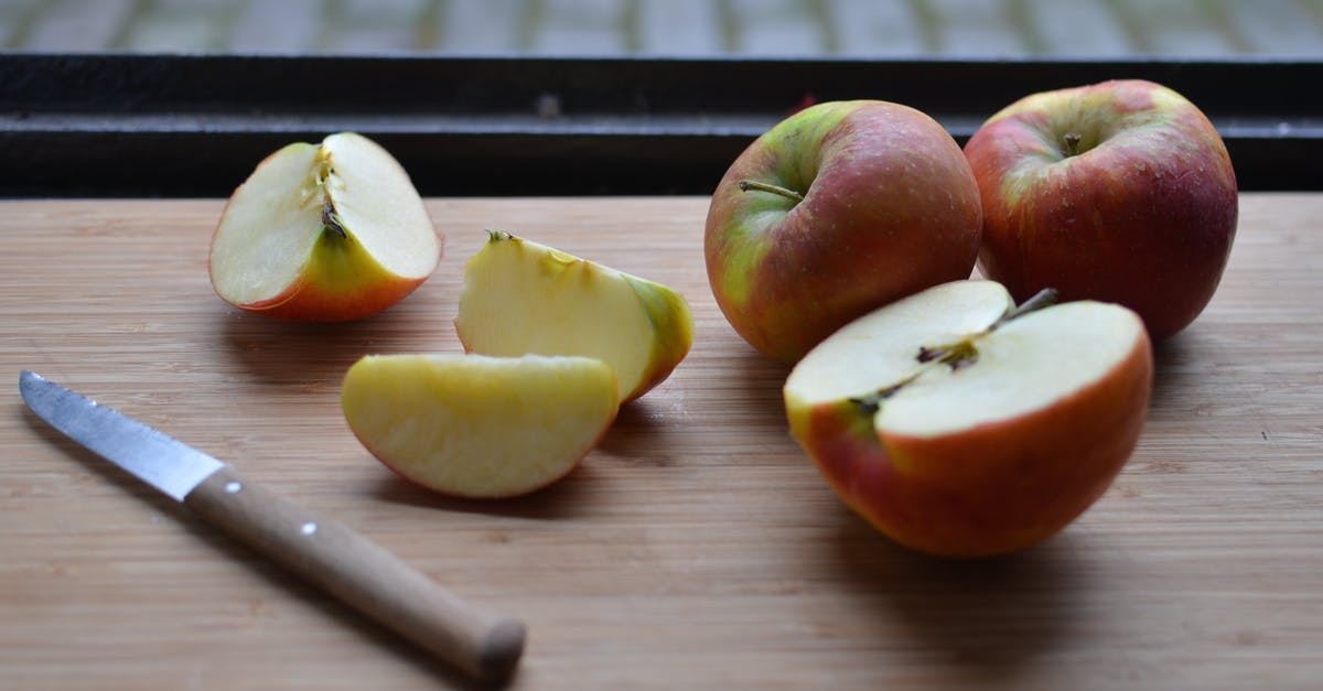 Optimal shape to cut apples for apple pie - Board with slices of fresh apples and knife near window Optimal shape to cut apples for apple pie - Board with slices of fresh apples and knife near window
