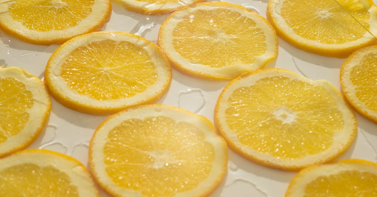 Orange peel loose/baggy around orange: Is that a problem? - Closeup background of fresh juicy orange slices arranged on white surface with clear ice Orange peel loose/baggy around orange: Is that a problem? - Closeup background of fresh juicy orange slices arranged on white surface with clear ice
