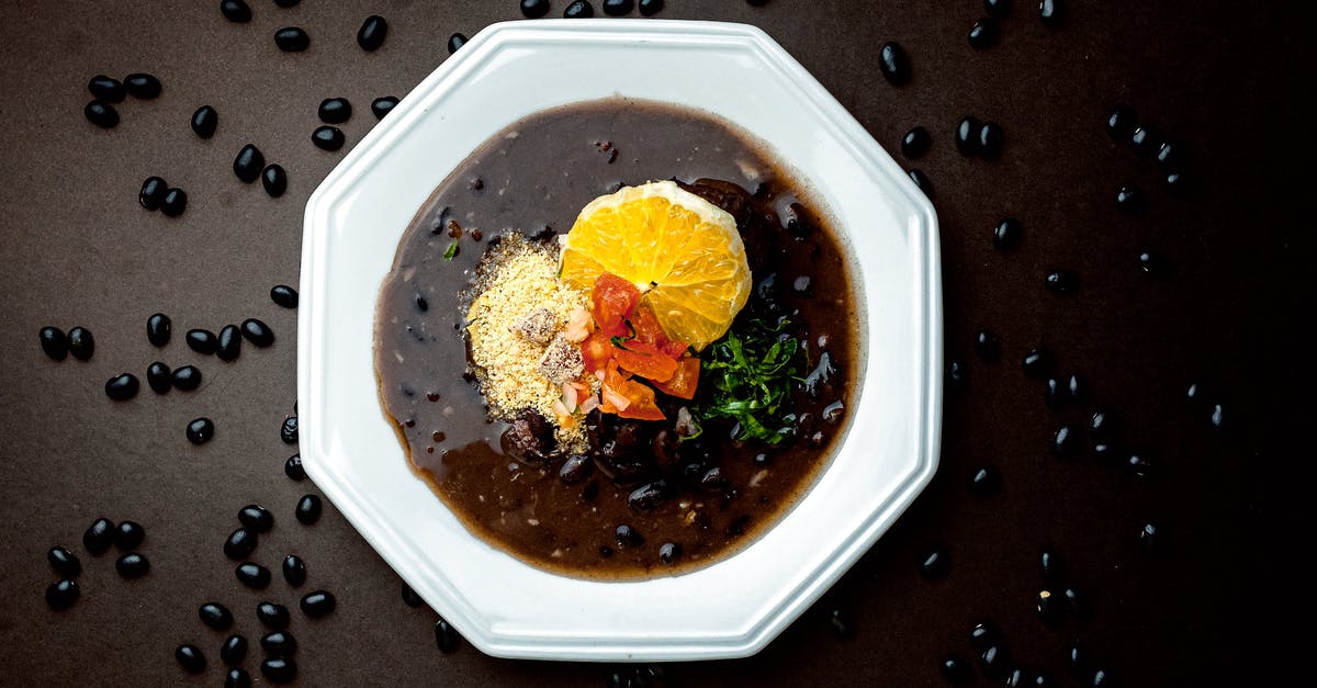 Orange sauce for goose - Soup with orange and olive in bowl Orange sauce for goose - Soup with orange and olive in bowl