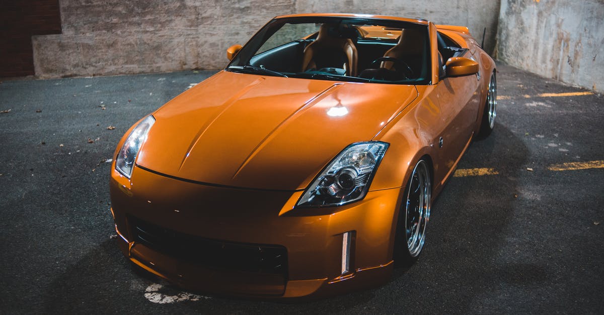 Orange spots on dry chickpea - Colorful modern sports car on asphalt pavement at dusk Orange spots on dry chickpea - Colorful modern sports car on asphalt pavement at dusk